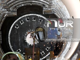 A construction worker builds petrochemical equipment parts at Lanshi Heavy Machinery Co., LTD., Hongshiya Street, in Qingdao, China, on Octo...