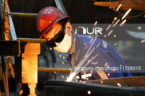 A construction worker builds petrochemical equipment parts at Lanshi Heavy Machinery Co., LTD., Hongshiya Street, in Qingdao, China, on Octo...