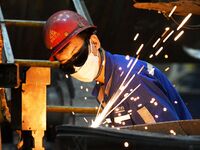 A construction worker builds petrochemical equipment parts at Lanshi Heavy Machinery Co., LTD., Hongshiya Street, in Qingdao, China, on Octo...