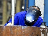 A construction worker builds petrochemical equipment parts at Lanshi Heavy Machinery Co., LTD., Hongshiya Street, in Qingdao, China, on Octo...