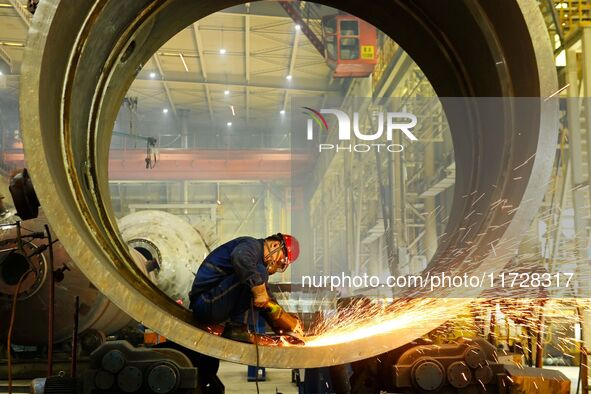 A construction worker builds petrochemical equipment parts at Lanshi Heavy Machinery Co., LTD., Hongshiya Street, in Qingdao, China, on Octo...