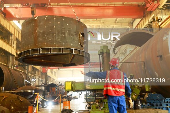 A construction worker builds petrochemical equipment parts at Lanshi Heavy Machinery Co., LTD., Hongshiya Street, in Qingdao, China, on Octo...