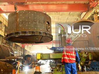 A construction worker builds petrochemical equipment parts at Lanshi Heavy Machinery Co., LTD., Hongshiya Street, in Qingdao, China, on Octo...