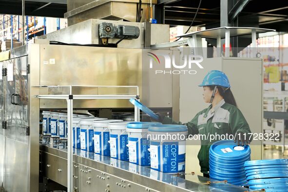 A worker produces lubricating oil on a production line at Qingdao Compton Technology Co LTD in Hongshiya Street, Qingdao, China, on October...