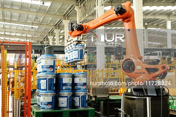 A worker produces lubricating oil on a production line at Qingdao Compton Technology Co LTD in Hongshiya Street, Qingdao, China, on October...