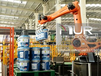 A worker produces lubricating oil on a production line at Qingdao Compton Technology Co LTD in Hongshiya Street, Qingdao, China, on October...