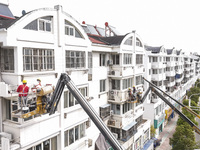 Workers renovate the Dongfeng Garden residential area in the Qingjiangpu district of Huai'an City, Jiangsu province, China, on November 1, 2...