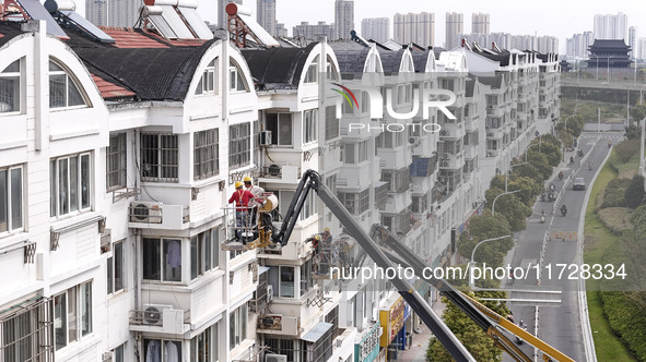 Workers renovate the Dongfeng Garden residential area in the Qingjiangpu district of Huai'an City, Jiangsu province, China, on November 1, 2...