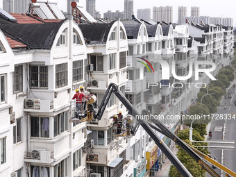 Workers renovate the Dongfeng Garden residential area in the Qingjiangpu district of Huai'an City, Jiangsu province, China, on November 1, 2...