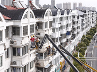 Workers renovate the Dongfeng Garden residential area in the Qingjiangpu district of Huai'an City, Jiangsu province, China, on November 1, 2...