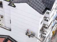 Workers renovate the Dongfeng Garden residential area in the Qingjiangpu district of Huai'an City, Jiangsu province, China, on November 1, 2...