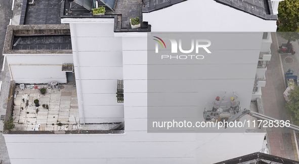 Workers renovate the Dongfeng Garden residential area in the Qingjiangpu district of Huai'an City, Jiangsu province, China, on November 1, 2...