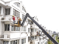 Workers renovate the Dongfeng Garden residential area in the Qingjiangpu district of Huai'an City, Jiangsu province, China, on November 1, 2...