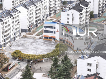 Workers renovate the Dongfeng Garden residential area in the Qingjiangpu district of Huai'an City, Jiangsu province, China, on November 1, 2...