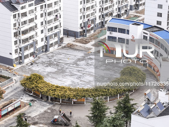 Workers renovate the Dongfeng Garden residential area in the Qingjiangpu district of Huai'an City, Jiangsu province, China, on November 1, 2...