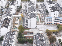 Workers renovate the Dongfeng Garden residential area in the Qingjiangpu district of Huai'an City, Jiangsu province, China, on November 1, 2...