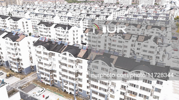 Workers renovate the Dongfeng Garden residential area in the Qingjiangpu district of Huai'an City, Jiangsu province, China, on November 1, 2...