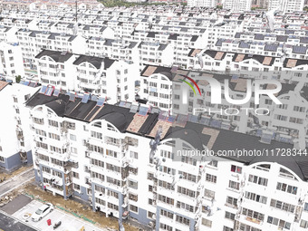 Workers renovate the Dongfeng Garden residential area in the Qingjiangpu district of Huai'an City, Jiangsu province, China, on November 1, 2...