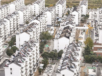 Workers renovate the Dongfeng Garden residential area in the Qingjiangpu district of Huai'an City, Jiangsu province, China, on November 1, 2...