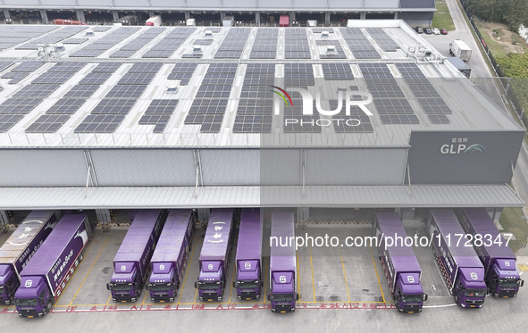 Express trucks from several companies load and unload parcels at a logistics park in the Huaian Economic and Technological Development Zone...