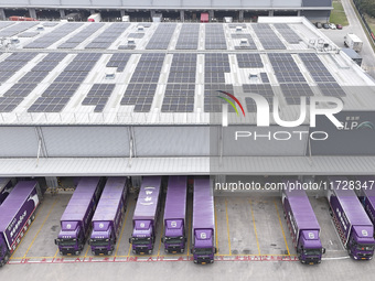 Express trucks from several companies load and unload parcels at a logistics park in the Huaian Economic and Technological Development Zone...