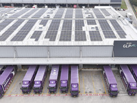 Express trucks from several companies load and unload parcels at a logistics park in the Huaian Economic and Technological Development Zone...