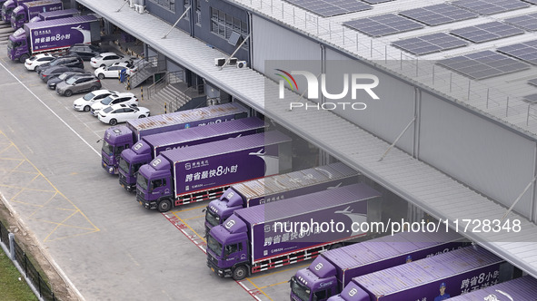 Express trucks from several companies load and unload parcels at a logistics park in the Huaian Economic and Technological Development Zone...