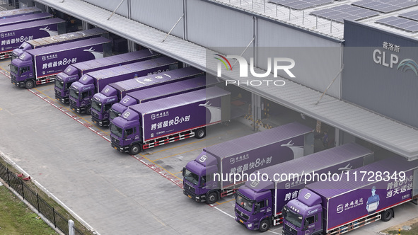 Express trucks from several companies load and unload parcels at a logistics park in the Huaian Economic and Technological Development Zone...