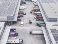 Express trucks from several companies load and unload parcels at a logistics park in the Huaian Economic and Technological Development Zone...