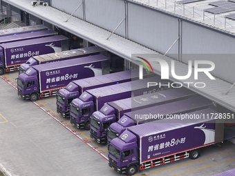 Express trucks from several companies load and unload parcels at a logistics park in the Huaian Economic and Technological Development Zone...