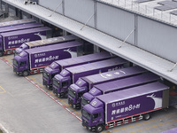 Express trucks from several companies load and unload parcels at a logistics park in the Huaian Economic and Technological Development Zone...