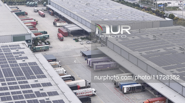 Express trucks from several companies load and unload parcels at a logistics park in the Huaian Economic and Technological Development Zone...