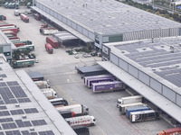 Express trucks from several companies load and unload parcels at a logistics park in the Huaian Economic and Technological Development Zone...