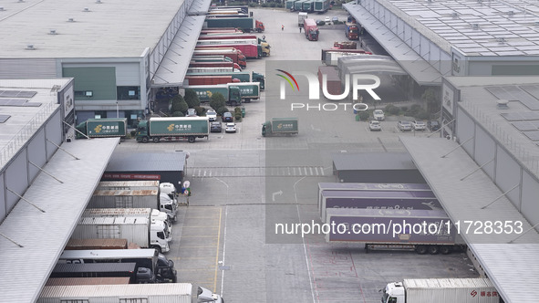 Express trucks from several companies load and unload parcels at a logistics park in the Huaian Economic and Technological Development Zone...