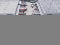 Express trucks from several companies load and unload parcels at a logistics park in the Huaian Economic and Technological Development Zone...