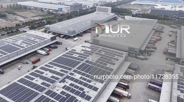 Express trucks from several companies load and unload parcels at a logistics park in the Huaian Economic and Technological Development Zone...