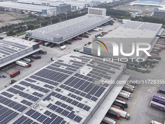 Express trucks from several companies load and unload parcels at a logistics park in the Huaian Economic and Technological Development Zone...