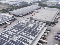 Express trucks from several companies load and unload parcels at a logistics park in the Huaian Economic and Technological Development Zone...