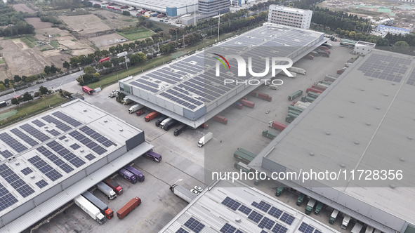 Express trucks from several companies load and unload parcels at a logistics park in the Huaian Economic and Technological Development Zone...