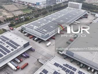 Express trucks from several companies load and unload parcels at a logistics park in the Huaian Economic and Technological Development Zone...