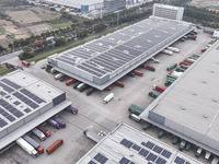 Express trucks from several companies load and unload parcels at a logistics park in the Huaian Economic and Technological Development Zone...