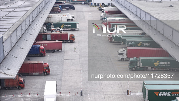 Express trucks from several companies load and unload parcels at a logistics park in the Huaian Economic and Technological Development Zone...