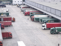 Express trucks from several companies load and unload parcels at a logistics park in the Huaian Economic and Technological Development Zone...