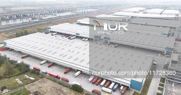 Express trucks from several companies load and unload parcels at a logistics park in the Huaian Economic and Technological Development Zone...