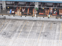 Express trucks from several companies load and unload parcels at a logistics park in the Huaian Economic and Technological Development Zone...