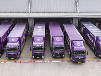 Express trucks from several companies load and unload parcels at a logistics park in the Huaian Economic and Technological Development Zone...