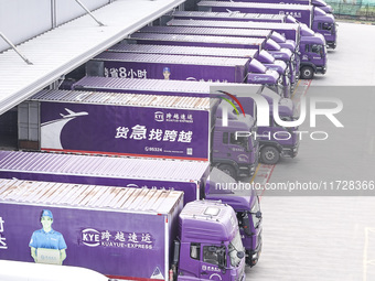 Express trucks from several companies load and unload parcels at a logistics park in the Huaian Economic and Technological Development Zone...