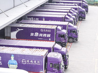 Express trucks from several companies load and unload parcels at a logistics park in the Huaian Economic and Technological Development Zone...