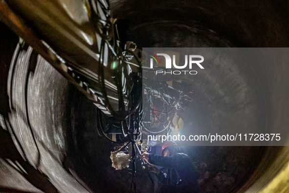 An employee works on a large pressure vessel customized by an oil refinery at the production workshop of Qingdao Lanshi Heavy Machinery Equi...