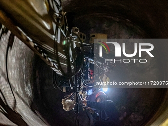 An employee works on a large pressure vessel customized by an oil refinery at the production workshop of Qingdao Lanshi Heavy Machinery Equi...